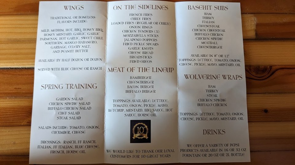 Printed menu page with wings and subs.