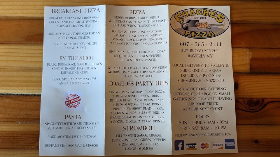 Restaurant menu listing pizzas, salads, and fries.